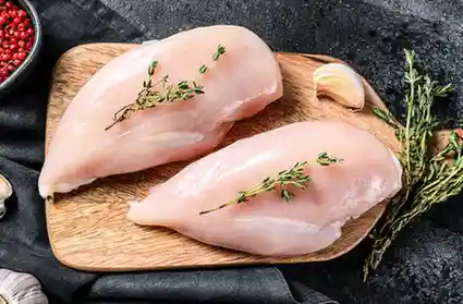 Chicken Breast-mansoura city gym Chicken breast on a wooden cutting board