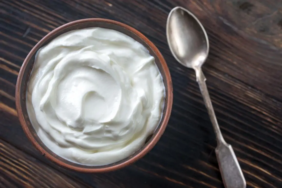 greek-yoghurt-mansoura city gym Greek yogurt in a bowl and a spoon is shown nearby it